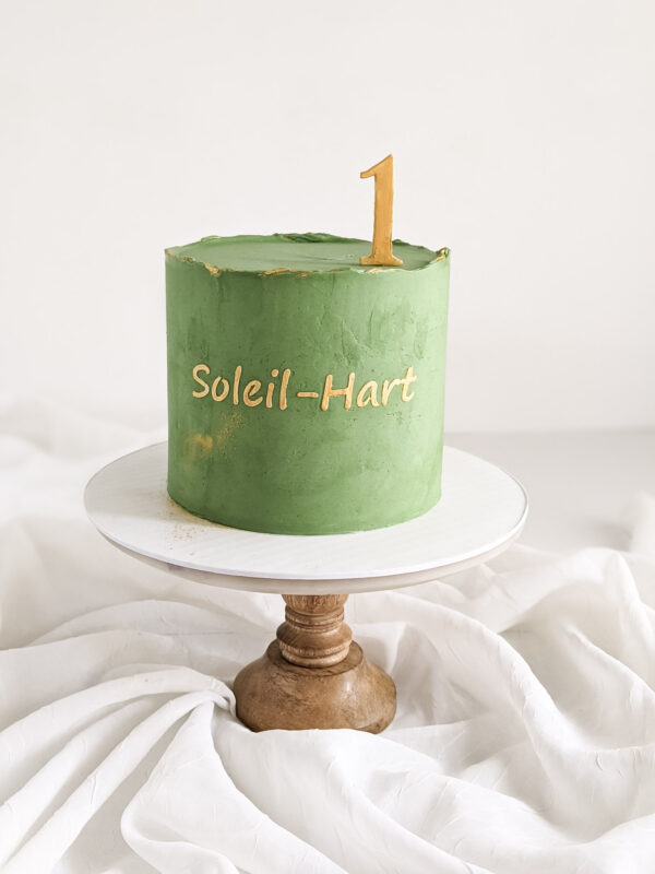 Green Cake with gold script name and gold 1 topper